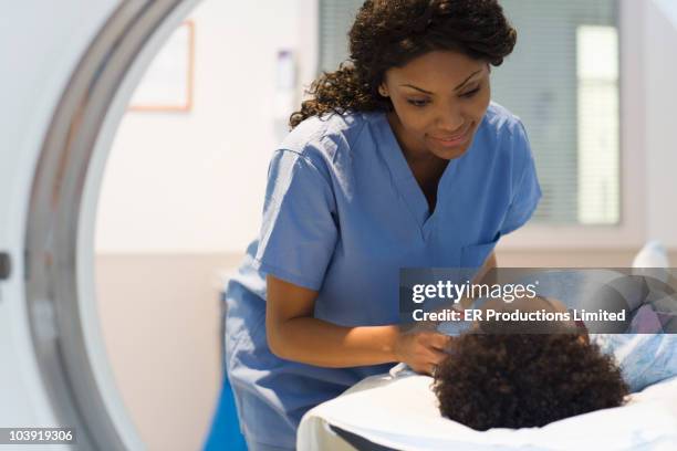 doctor preparing patient for mri - doctor african child stock-fotos und bilder