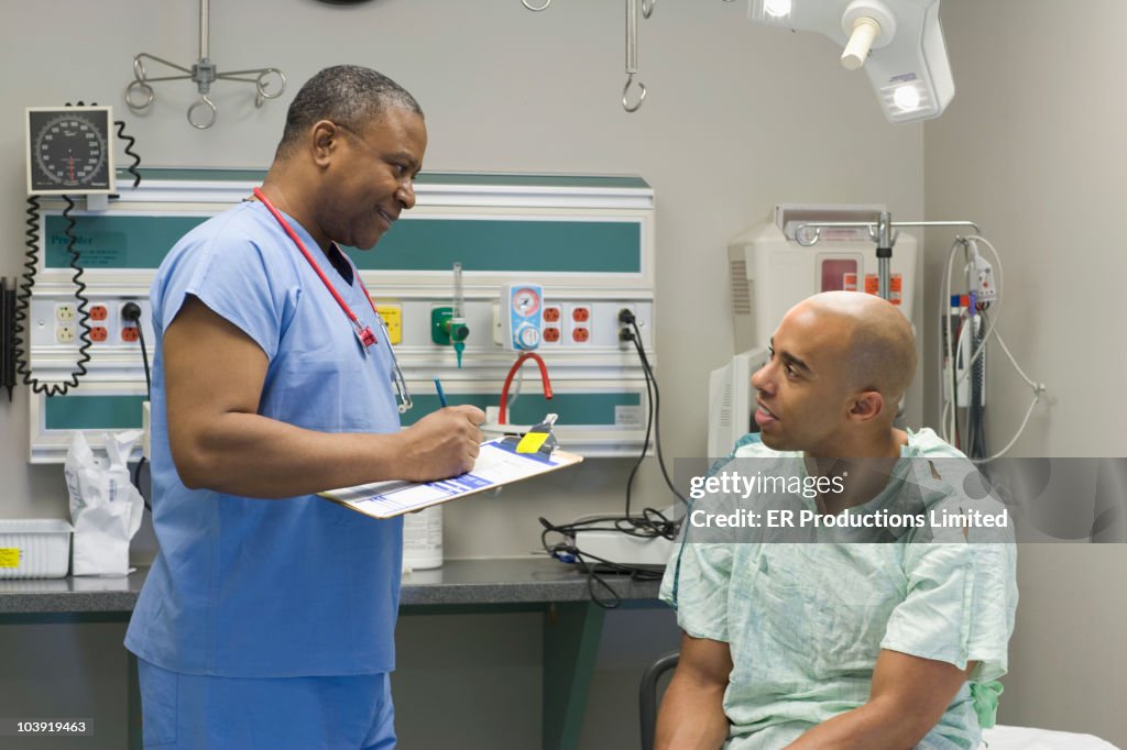 Black doctor questioning patient in hospital