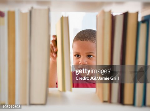 African American boy selecting book African American boy selecting book