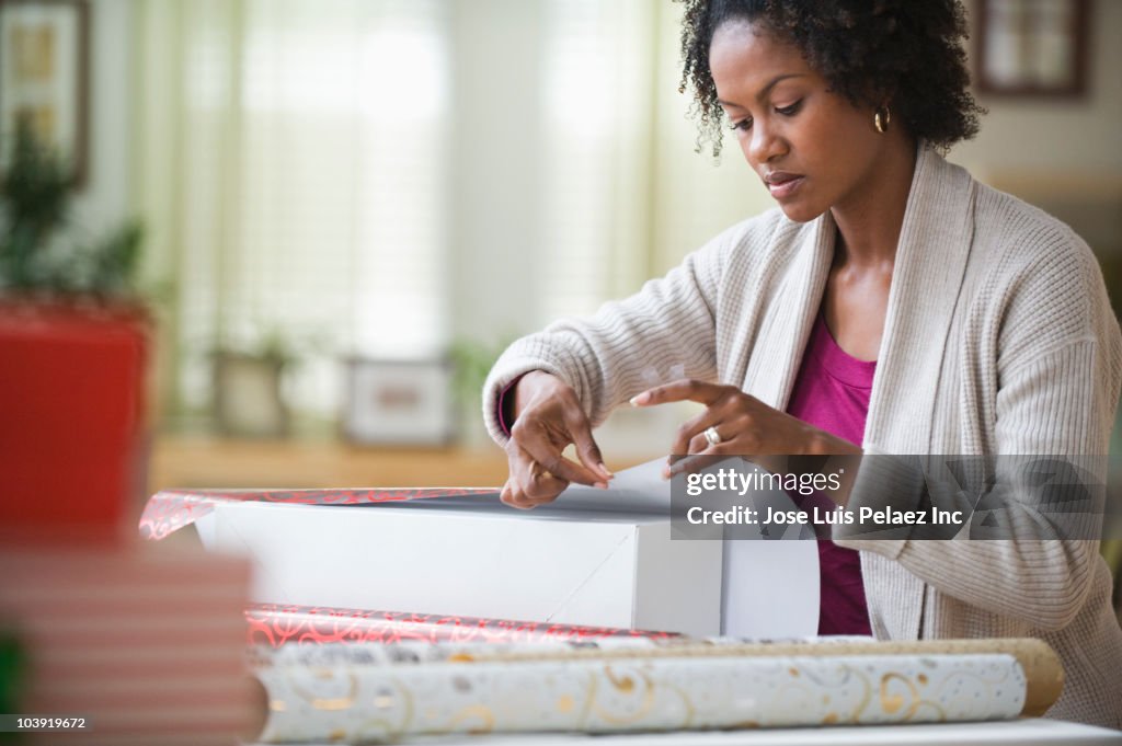 Black woman wrapping gift