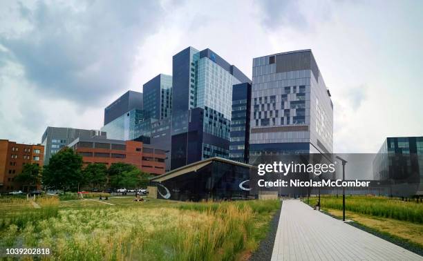 montreal's new chum hospital and research facility with metro station in the foreground - hospital in montreal quebec stock pictures, royalty-free photos & images