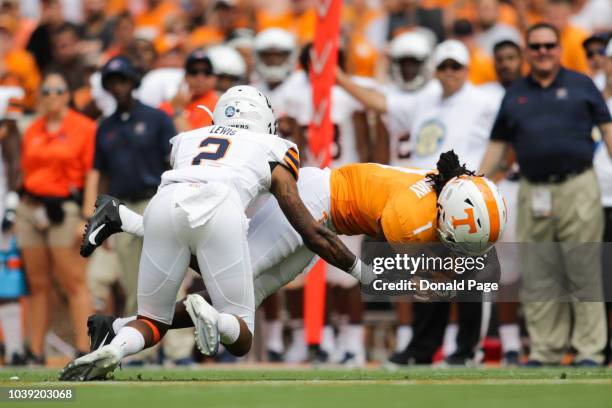 Defensive back Michael Lewis of the UTEP Miners tackles Wide receiver Marquez Callaway of the Tennessee Volunteers during the game between the UTEP...