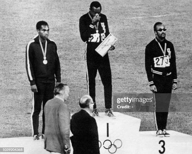 Jim Hines of the USA , Lennox Miller of Jamaica and Charles Greene of the USA stand on the podium 14 October 1968 after receiving their medals for...