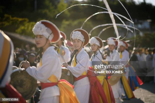 Performers take part in a traditional dance at the Namsangol hanok village in Seoul on September 24, 2018. South Koreans are observing the annual...