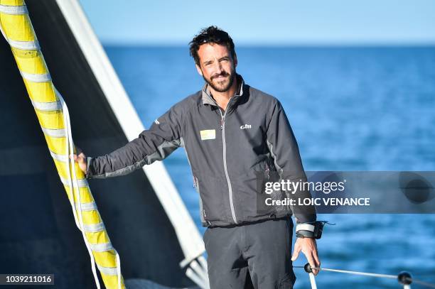 French sailor Louis Burton poses onboard his Imoca 60 monohull Bureau Vallee, as he sails from Lorient to Saint-Malo, on September 24 a few weeks...