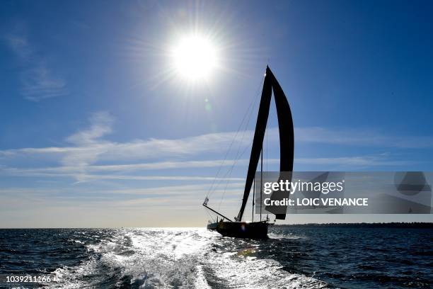 French sailor Louis Burton poses onboard his Imoca 60 monohull Bureau Vallee, as he sails from Lorient to Saint-Malo, on September 24 a few weeks...