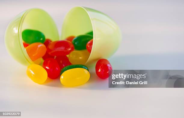 jelly beans in a plastic easter egg - jellybean stock pictures, royalty-free photos & images