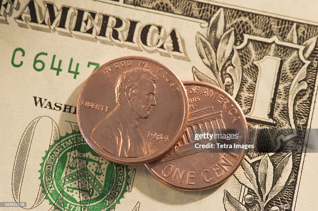 Pennies on top of American dollar bill