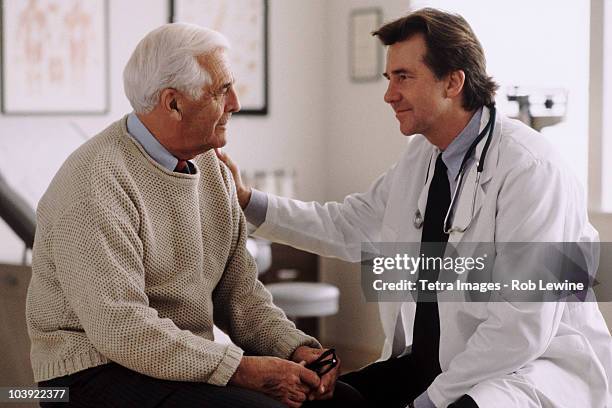 doctor consulting with patient - mature men talking stock pictures, royalty-free photos & images