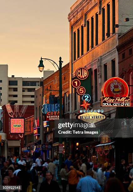 crowd of people and buildings on beale street in memphis - memphis tennessee stock pictures, royalty-free photos & images