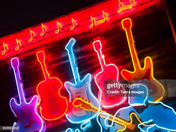 illuminated guitars on beale street in memphis - luce fluorescente foto e immagini stock