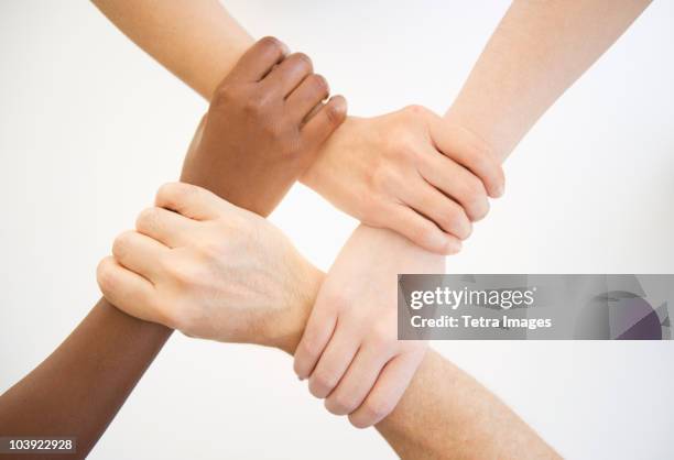 four hands holding wrists of other people - wrist stock pictures, royalty-free photos & images