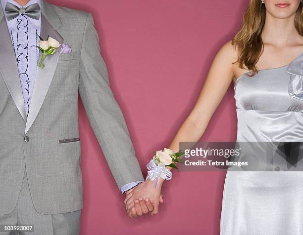 couple in prom attire holding hands - corsage imagens e fotografias de stock