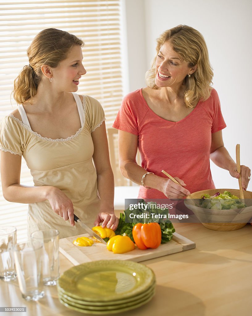 Two women preparing salad