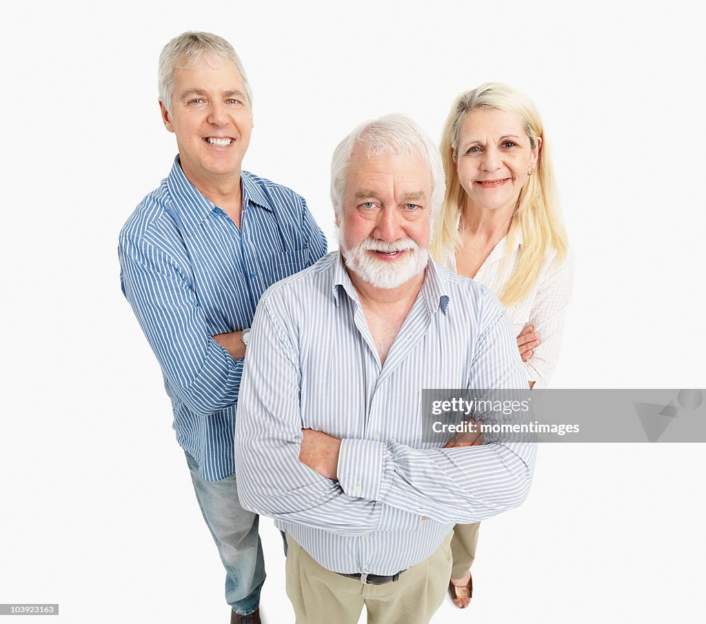 Three people standing with their arms crossed