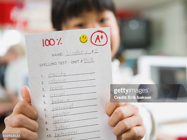 elementary student holding an a grade paper - provo 個照片及圖片檔