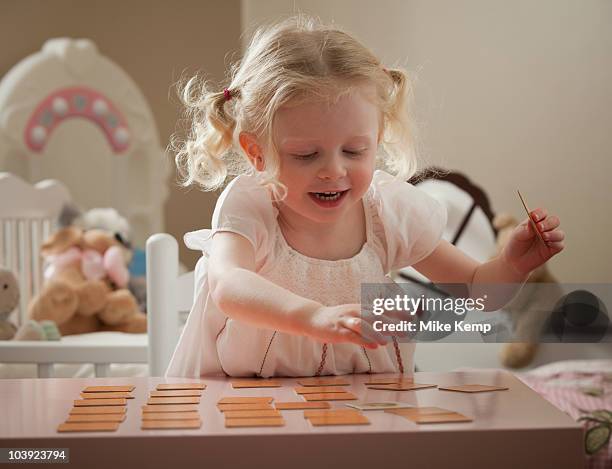 young girl playing memory game - erinnerung stock-fotos und bilder