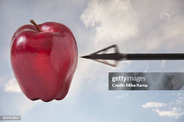 arrow pointing at apple in the sky - apple arrow stock-fotos und bilder