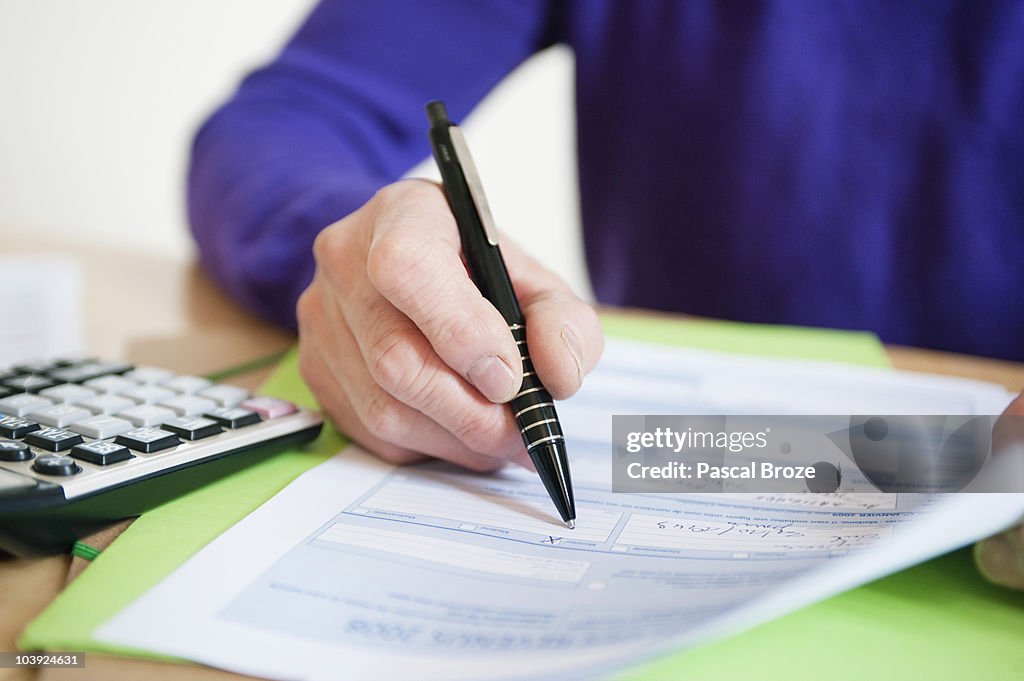 Man filling his tax form