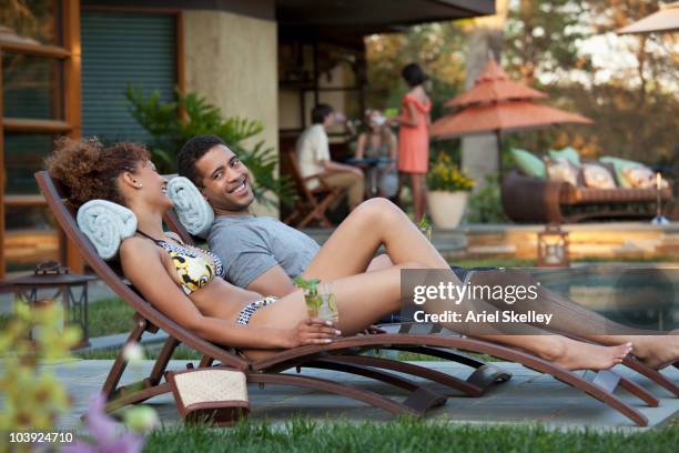 couple relaxing poolside - resort pool stock-fotos und bilder