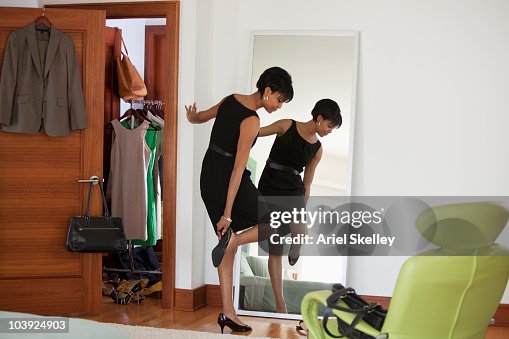 African American woman dressing in bedroom African American woman dressing in bedroom