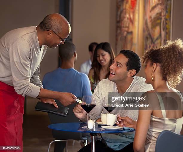 customers paying waiter at restaurant - restaurant bill stock pictures, royalty-free photos & images