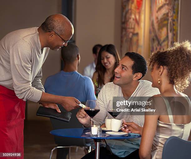 customers paying waiter at restaurant - paying for dinner imagens e fotografias de stock