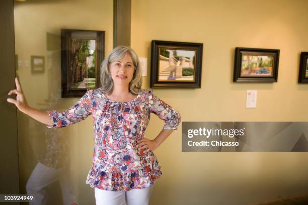 caucasian woman leaning on doorway - la art show stock pictures, royalty-free photos & images