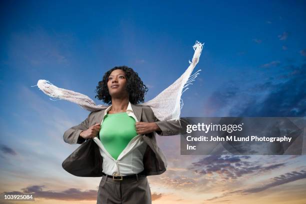 black superhero changing clothes outdoors - hero corp stock pictures, royalty-free photos & images