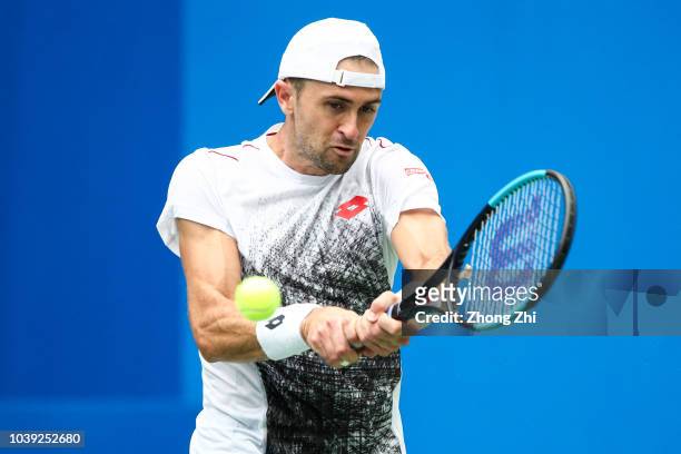 Tim Smyczek of the United States returns a shot against Joao Sousa of Portugal during 2018 ATP Chengdu Open at Sichuan International Tennis Centre on...