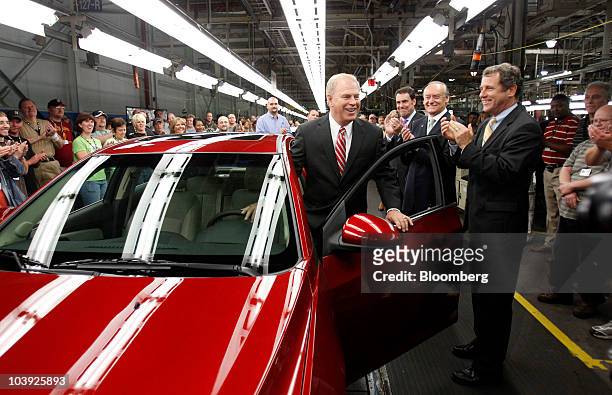 Ted Strickland, governor of Ohio, gets into a General Motors Co. Chevrolet Cruze as Mark Reuss, Mark Reuss, president of North America for GM, third...