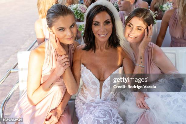 Danielle Staub with daughters Christine and Jillian posing at Danielle's wedding on May 5, 2018 in Bimini, Bahamas.