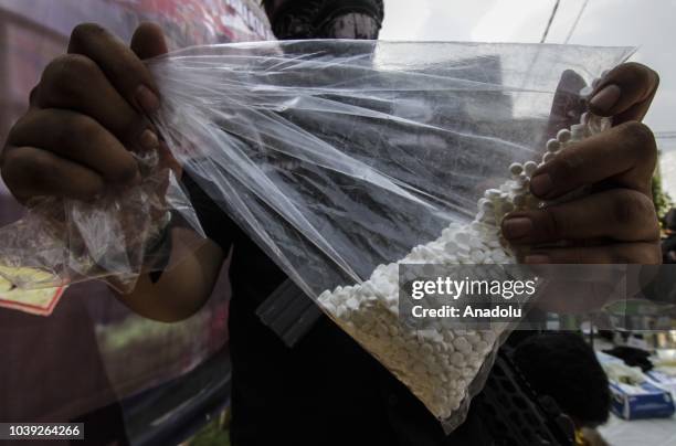 An officers shows collected evidence in an operation on an ecstasy factory at Sentra Pondok Rajeg Housing, in Cibinong, Bogor, West Java, Indonesia...