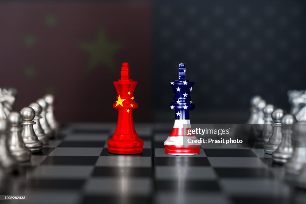 USA and China trade relations, cooperation strategy. US America and China flags on chess king on a chessboard.