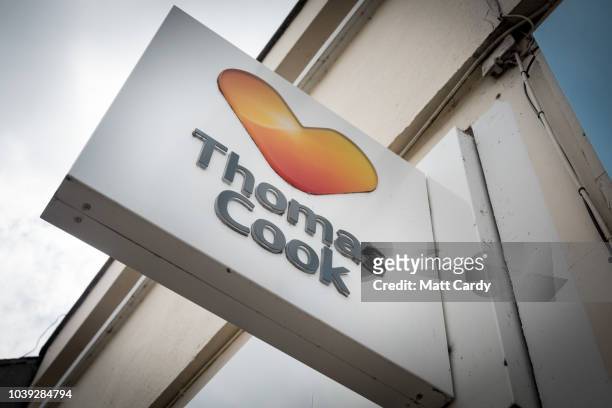 People pass a branch of Thomas Cook holiday shop on September 24, 2018 in Keynsham, England. The travel agent Thomas Cook has blamed the summer...