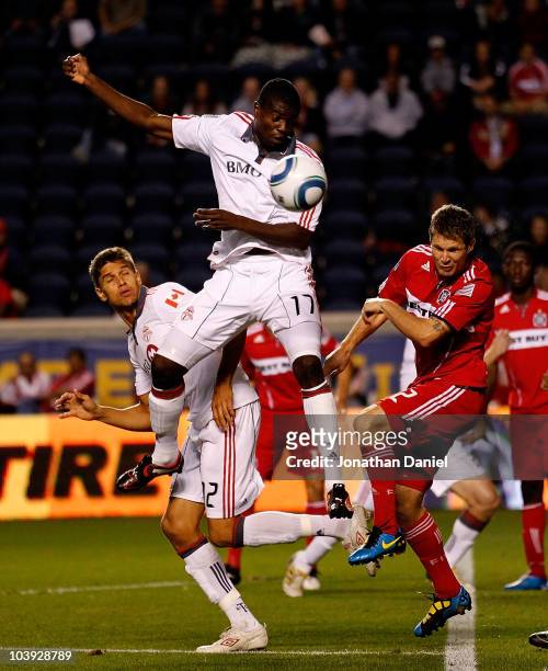 Logan Pause of the Chicago Fire heads the ball away from O'Brian White and Adrian Cann of Toronto FC in an MLS match on September 8, 2010 at Toyota...