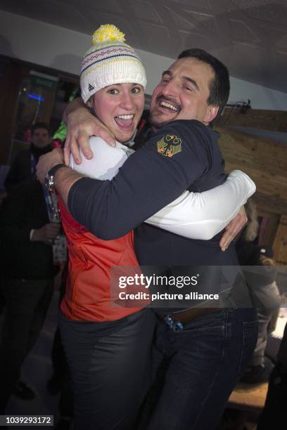 Natalie Geisenberger of Germany celebrates with Georg Hackl after winning the gold medal at the Women's Luge Singles Run in the German House at the...