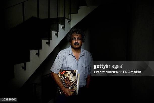 India-history-photography-Gandhi" FEATURE by Neha Lall In this August 10, 2010 photograph, Indian photographer Aditya Arya poses with his book...