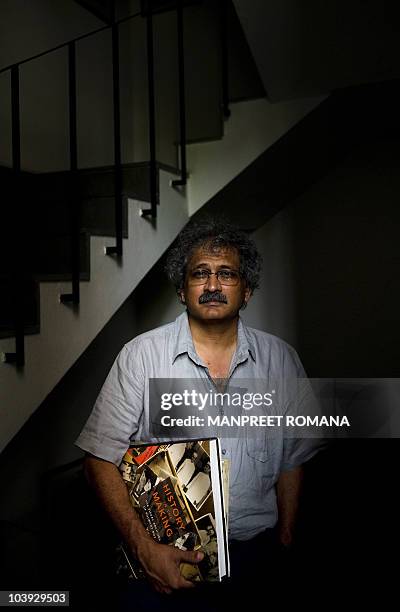 India-history-photography-Gandhi" FEATURE by Neha Lall In this August 10, 2010 photograph, Indian photographer Aditya Arya poses with his book...