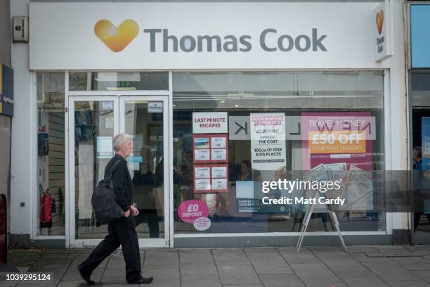 Man passes a branch of Thomas Cook holiday shop on September 24, 2018 in Keynsham, England. The travel agent Thomas Cook has blamed the summer...