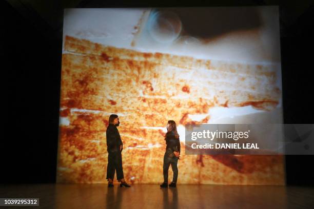 Tate Britain employees pose for a photograph in front of the shortlisted Turner Prize 2018 entry by New Zealand artist Luke Willis Thompson at Tate...