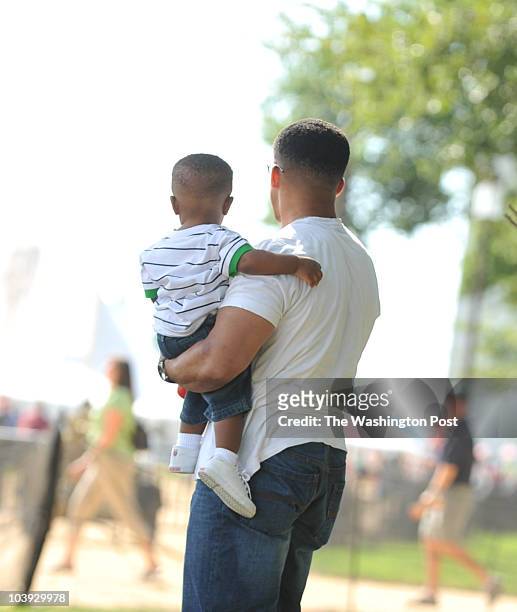 September 13, 2009 PLACE: Washington, DC PHOTOGRAPHER: jahi chikwendiu/twp CAPTION: Eric Holmes, of Upper Marlboro, MD, holds his son Hill Holmes at...