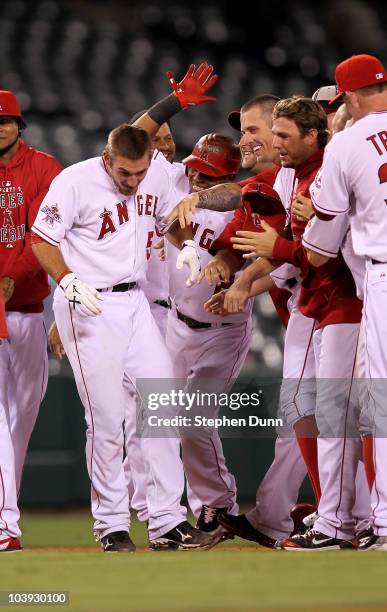 Jeff Mathis of the Los Angeles Angels of Anaheim is mobbed by teammates after hitting a walk off sacrifice fly to score Torii Hunter form third base...