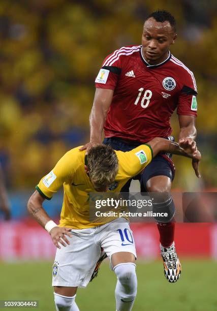 Neymar of Brazil and Juan Zuniga of Colombia vie for the ball during the FIFA World Cup 2014 quarter final match soccer between Brazil and Colombia...