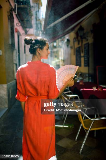 woman using hand fan. - seville sightseeing stock pictures, royalty-free photos & images