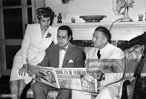 Eva Peron and her husband, Argentine President Juan Peron and Colonel Mercante read in Buenos Aires "Democracia", issue of 24 February 1946, the...