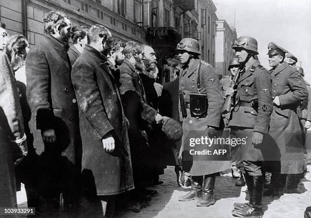 File picture taken in 1943 of Nazi German soldiers questioning Jews after the Warsaw Ghetto Uprising. In October 1940, the Nazis began to concentrate...