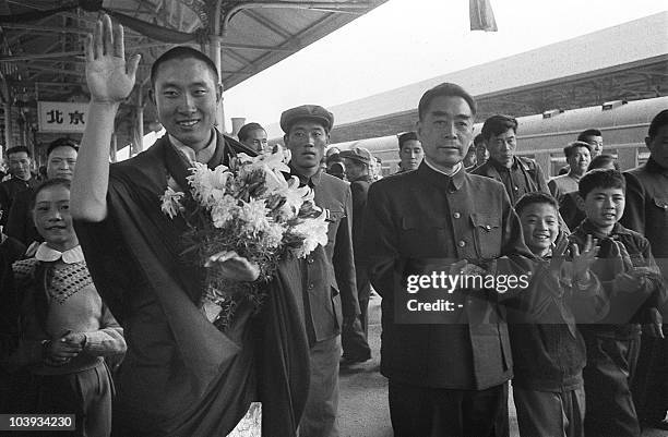 Smiling and waving Panchen Lama , a spiritual leader and teacher in Tibetan Buddhism , is welcomed 20 April 1959 at Beijing railway station by...