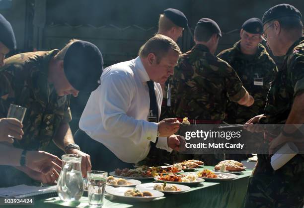 Judges taste a meal presented by army military chefs which they have just cooked in a field catering competition, at Old Cater Barracks in Bulford on...