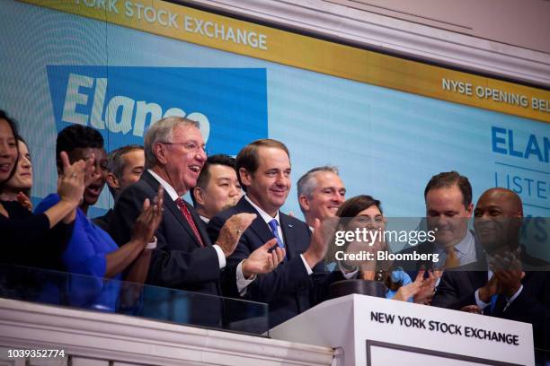 Jeff Simmons, president and chief executive officer of Elanco Animal Health Inc., center, applauds while ringing the opening bell on the floor of the...